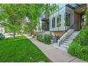 Charming home with green lawn and walkway leading to the front door at 2565 Champa St, Denver, CO 80205