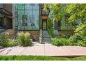 Modern home with striking architectural details, green landscaping, and a welcoming entrance at 2565 Champa St, Denver, CO 80205