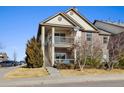 Two-story condo featuring covered balconies and well-manicured grounds, offering a comfortable and inviting exterior at 23405 E 5Th Pl # 201, Aurora, CO 80018