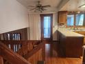 View of the entryway and stairs from the second floor to the kitchen area with hardwood floors at 812 S Ouray St, Aurora, CO 80017