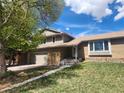 Charming two-story home with attached two car garage and brick and siding exterior on a lush lot at 812 S Ouray St, Aurora, CO 80017