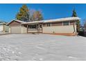 Brick ranch home with a snow-covered lawn at 14059 W 5Th Ave, Golden, CO 80401