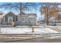 Renovated gray house with a white porch, snow on the ground at 3500 N Marion St, Denver, CO 80205