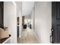 Inviting foyer with light wood floors, a bench, and view into the open living space at 8080 E Dartmouth Ave # 26, Denver, CO 80231