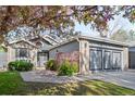 Charming single-story home with lush landscaping, a well-manicured lawn, and an attached two-car garage at 8080 E Dartmouth Ave # 26, Denver, CO 80231