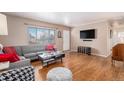 Spacious living room with hardwood floors and a gray sectional sofa at 12008 W Mexico Pl, Lakewood, CO 80228