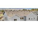 Aerial close-up of a well-maintained roof with gray siding and a view of the surrounding neighborhood at 174 Rockingham Cir, Castle Pines, CO 80108