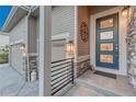 Welcoming front entrance featuring stone accents, modern door, and stylish exterior lighting at 4213 Hickory Oaks St, Castle Rock, CO 80104