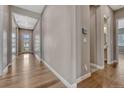 Bright hallway with hardwood floors leading to various rooms in the home at 4213 Hickory Oaks St, Castle Rock, CO 80104