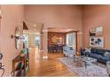 Spacious living room and dining area with hardwood floors, high ceilings, modern decor, and abundant natural light at 6614 W Gould Dr, Littleton, CO 80123