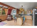 Charming kitchen featuring a granite island, stainless steel appliances, and abundant natural light at 12191 Tecumseh Trl, Conifer, CO 80433