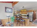 Bright kitchen featuring stainless steel appliances, stone countertops, and custom cabinetry at 12191 Tecumseh Trl, Conifer, CO 80433