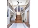 Grand foyer with a split staircase, high ceilings, and views of the mountains at 5668 Red Fern Ct, Littleton, CO 80125