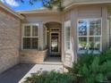 Inviting front entrance featuring detailed windows and a covered porch, creating a warm and welcoming entry point at 86 Woodland Cir, Highlands Ranch, CO 80126