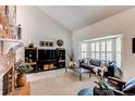 Inviting living room featuring a cozy fireplace, large windows with shutters, and stylish decor at 7682 S Cove Cir, Centennial, CO 80122