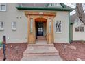 Inviting entryway features a wooden porch and stylish front door with glass panels and house number at 13200 E 160Th Ave, Brighton, CO 80602