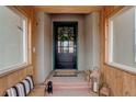 Charming front porch offers a warm welcome with a wreath, lanterns, and bench seating at 13200 E 160Th Ave, Brighton, CO 80602