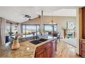 Spacious kitchen with granite countertops, wood cabinets, stainless appliances, and an open view at 6960 Buckskin Dr # 86, Littleton, CO 80125