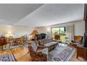 Living room featuring classic decor, hardwood floors, large windows and adjacent dining area at 12565 Sheridan Blvd # 105, Broomfield, CO 80020