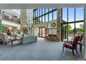 Condominium lobby with stone walls, high ceilings, and comfortable seating near large windows at 12565 Sheridan Blvd # 105, Broomfield, CO 80020