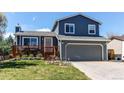Two-story home boasts a two-car garage, manicured lawn, and a charming deck, perfect for enjoying the outdoors at 8463 Wheatgrass Cir, Parker, CO 80134