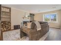 Comfortable living room with wood floors, a cozy fireplace, and stylish decor at 5573 S Lowell Blvd, Littleton, CO 80123