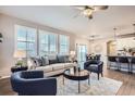 Open-concept living area showcases hardwood floors, abundant light, neutral paint, and seamless flow to the kitchen at 8695 Torrey St, Arvada, CO 80007