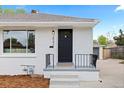 This home's exterior is newly painted and features an updated front entry and a well maintained yard at 2542 S Winona Ct, Denver, CO 80219