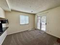 Bright living room with a sliding glass door leading to a balcony offering outdoor space and natural light at 12470 E Cornell Ave # 203, Aurora, CO 80014