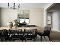 Bright dining area features modern lighting, an elegant table set and a view into the adjacent bedroom at 39575 Gwinett Cir, Elizabeth, CO 80107