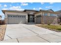 Lovely home with a three-car garage and a wide driveway at 19409 W 88Th Dr, Arvada, CO 80007