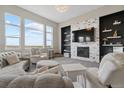 Inviting living room with large windows, fireplace and stylish decor at 19409 W 88Th Dr, Arvada, CO 80007