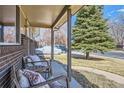 Cozy front porch with comfortable seating and a view of the surrounding neighborhood at 1255 S Hoyt St, Lakewood, CO 80232