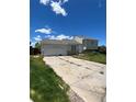 Charming two-story home featuring an attached garage and stone accents, set under a bright blue sky at 1415 S Pitkin Ct, Aurora, CO 80017