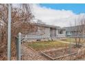 Single-story home with fenced yard and garden, showcasing the property's curb appeal at 117 6Th St, Frederick, CO 80530