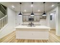 Bright kitchen features modern appliances, an island, and stylish pendant lighting at 8632 Hotchkiss St, Littleton, CO 80125