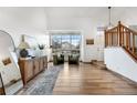 Inviting living area with wood floors, natural light, staircase and neutral decor at 8164 S York Ct, Centennial, CO 80122