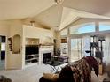 Living room features cathedral ceilings, large windows, and a fireplace with custom built-ins at 14353 E 1St Dr # 302, Aurora, CO 80011