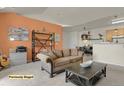 Staged living room features a comfortable couch and access to the kitchen and dining area at 14353 E 1St Dr # 302, Aurora, CO 80011