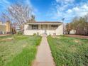 Charming single-story home with a well-maintained lawn and inviting walkway at 7881 Kenwood St, Commerce City, CO 80022