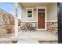 Inviting front porch with seating, perfect for enjoying the outdoors at 9777 W Stanford Ave, Denver, CO 80123