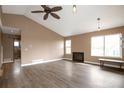 Light-filled living room with vaulted ceilings, a fireplace, hardwood floors, and large windows at 18950 E Kent Cir, Aurora, CO 80013