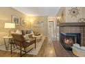 Comfortable living room featuring fireplace, neutral tones, and ample natural light at 6011 Yarrow St # C, Arvada, CO 80004
