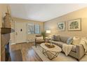 Comfortable living room with a decorative fireplace, hardwood floors and lots of light at 6011 Yarrow St # C, Arvada, CO 80004