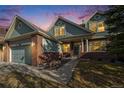 Charming two-story home featuring a brick facade, a well-manicured lawn, and a welcoming entrance with classic white columns at 22668 E Lake Pl, Centennial, CO 80015