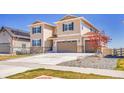 Inviting home with a three-car garage, landscaped front yard, and neutral-tone siding at 6880 S Yantley Ct, Aurora, CO 80016
