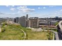 Aerial view showing multiple buildings with lush green spaces and parks in this vibrant neighborhood at 2000 Little Raven St # 4A, Denver, CO 80202