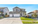 Two-story house with gray siding, white trim, and a two-car garage at 13432 Wabash St, Thornton, CO 80602