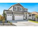 Two-story house with gray siding, white trim, and a two-car garage at 13432 Wabash St, Thornton, CO 80602