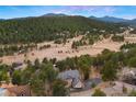 An aerial of a beautiful luxury home and lush surroundings at 30205 Telluride Ln, Evergreen, CO 80439